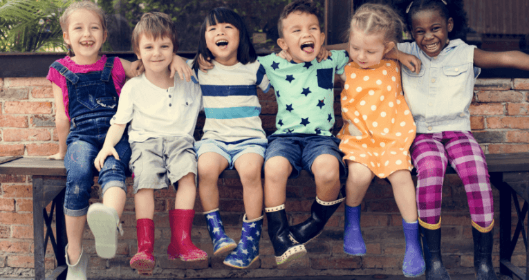 Happy children sitting on a bench