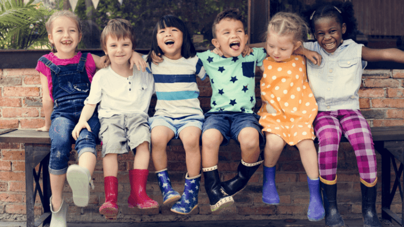 Happy children sitting on a bench