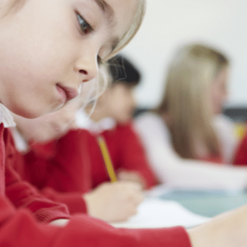 School child practising handwriting