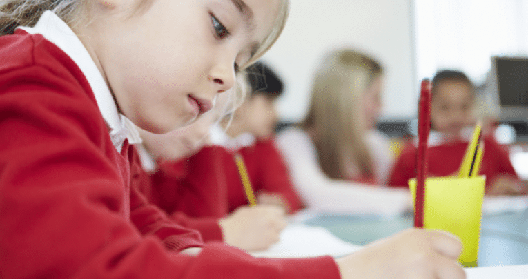 School child practising handwriting