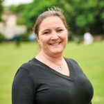 Woman in black top smiling