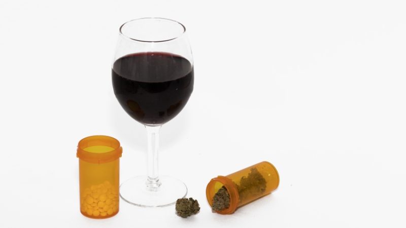 photograph of glass of wine and cannabis to illustrate concept of drugs and alcohol education
