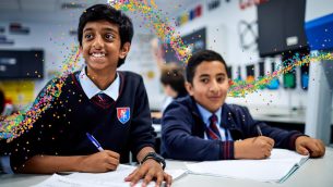 Two secondary school pupils smiling