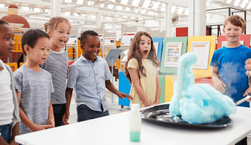 Kids watching science experiment representing science school trips