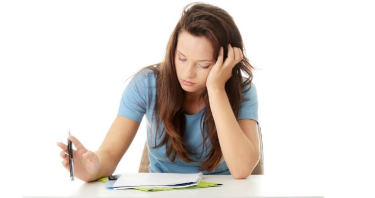 Close up on teenage girl sitting formal GCSE exam