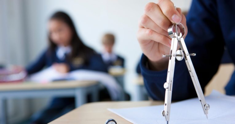 compass being used in a maths lesson against a blurred background