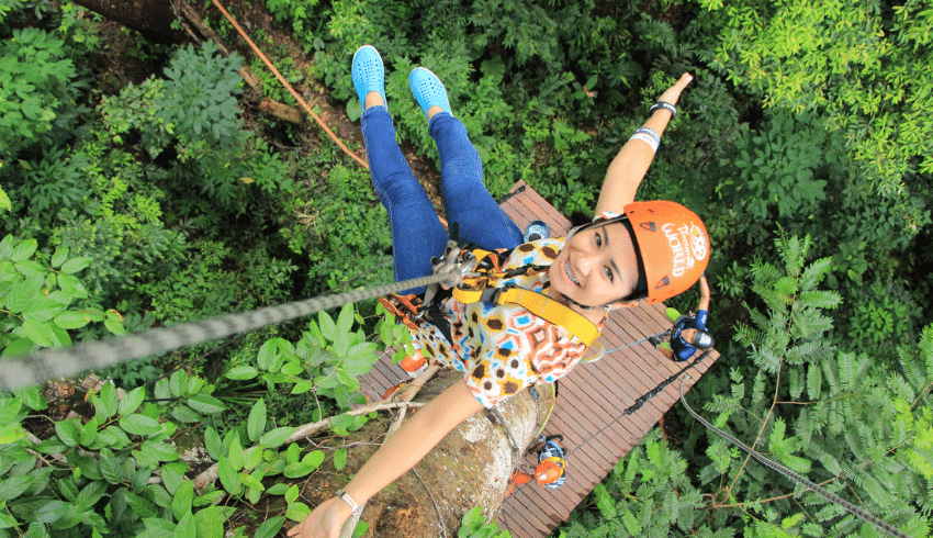School trips image of girl hanging from an abseil rope, smiling