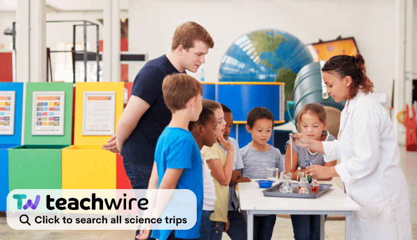 Children in lab watching scientist representing science school trips