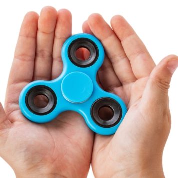 close-up photograph of hands holding a fidget spinner