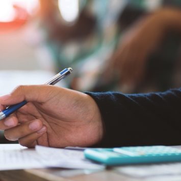 close-up on a school student completing a maths task in class