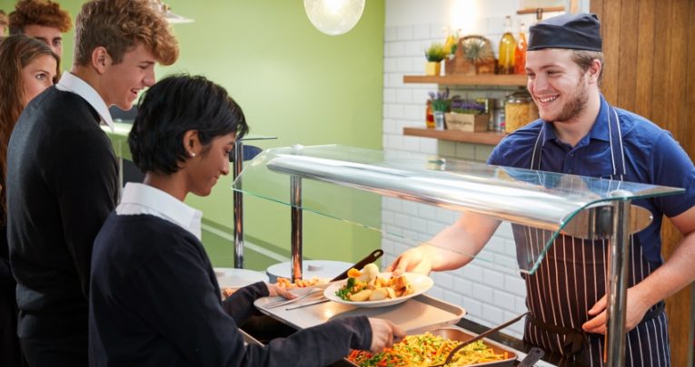 Photo of students queuing at a school cafeteria