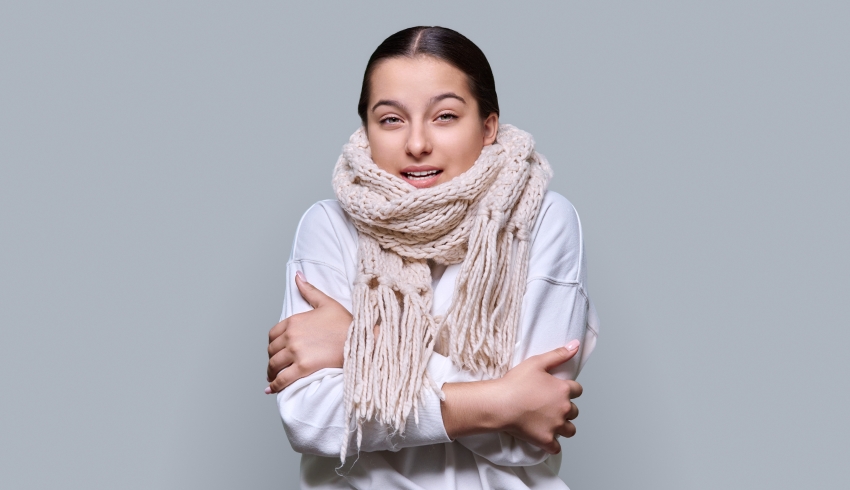 Photo of a visibly cold teenage girl wearing a scarf