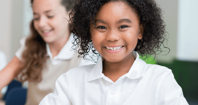 Child in school uniform smiling