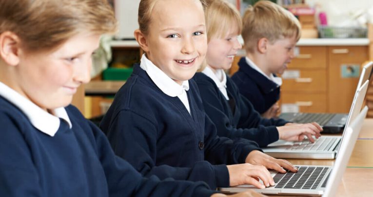 School children using laptops