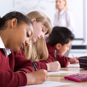 Children sitting SATs test in classroom