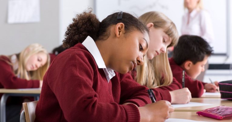 Children sitting SATs test in classroom