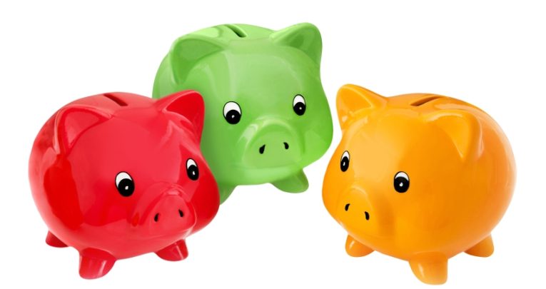 close-up photo of three differently-coloured children's piggy banks representing paying for extracurricular activities