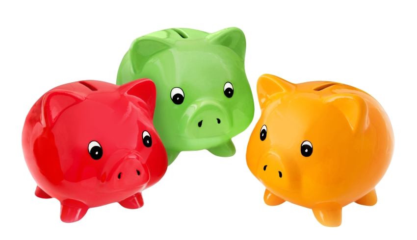 close-up photo of three differently-coloured children's piggy banks representing paying for extracurricular activities