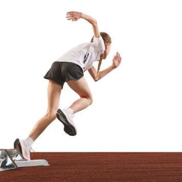 photo of teenage competitive sprinter starting a race