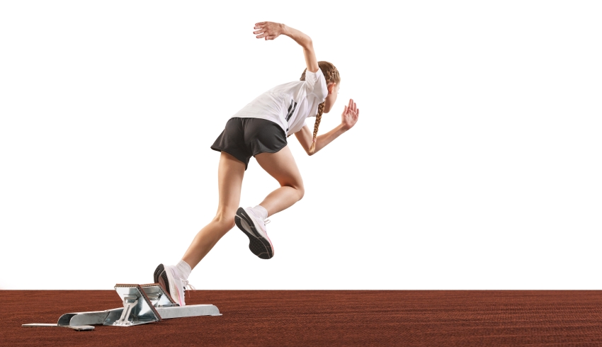 photo of teenage competitive sprinter starting a race