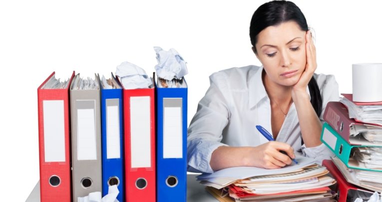 photo of tired woman completing administrative work