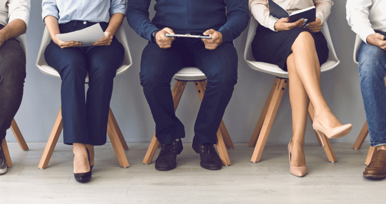 Body and legs of people waiting for interview, representing teacher interview questions