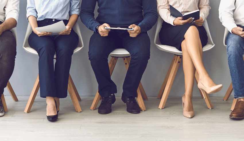 Body and legs of people waiting for interview, representing teacher interview questions