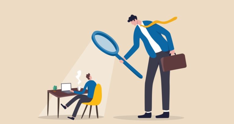 Illustration of large besuited figure holding a magnifying glass looming over a much smaller besuited figure working at a desk, representing Ofsted inspections