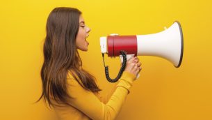 Photo of teenage girl talking through a loudhailer, representing oracy in the classroom