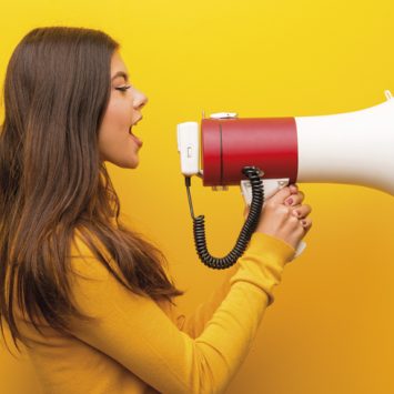 Photo of teenage girl talking through a loudhailer, representing oracy in the classroom