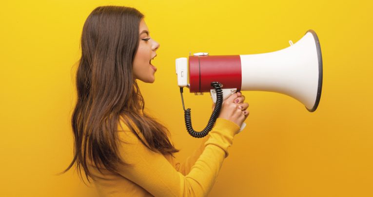 Photo of teenage girl talking through a loudhailer, representing oracy in the classroom