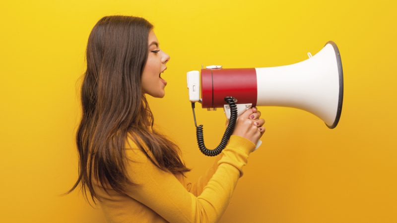 Photo of teenage girl talking through a loudhailer, representing oracy in the classroom