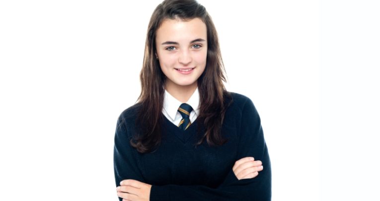 Photo of young teenaged girl wearing school uniform