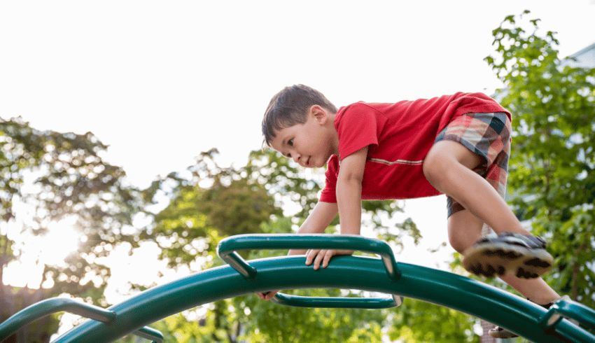 Child without a fixed mindset taking risks in a playground