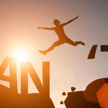 Person jumping from 'Can't' to 'Can' to represent fixed mindset