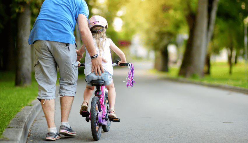 Girl learning how to ride a bike, representing fixed mindset vs growth mindset