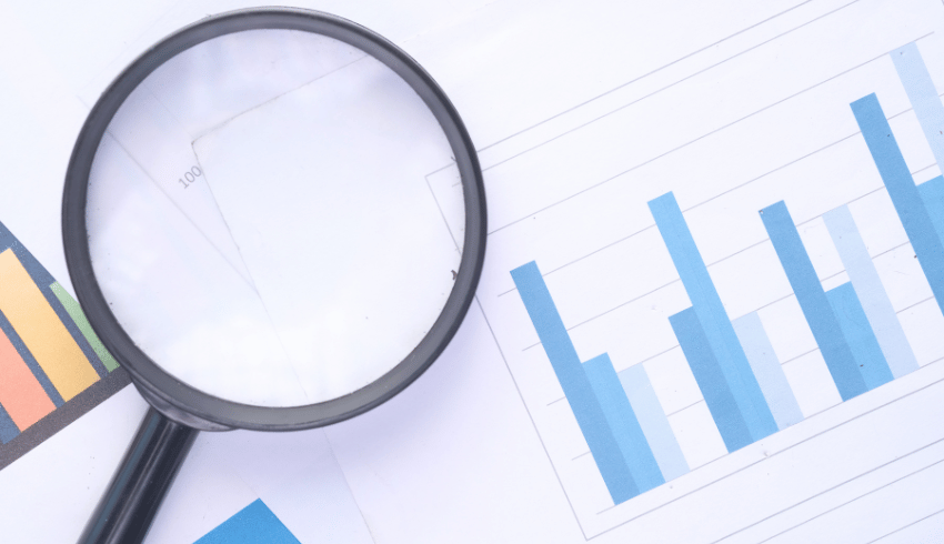 Magnifying glass and statistics, representing Ofsted Inspection Framework