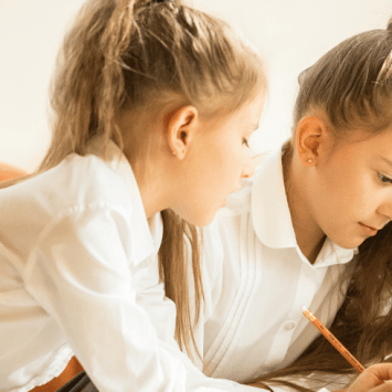 Two schoolchildren doing think pair share