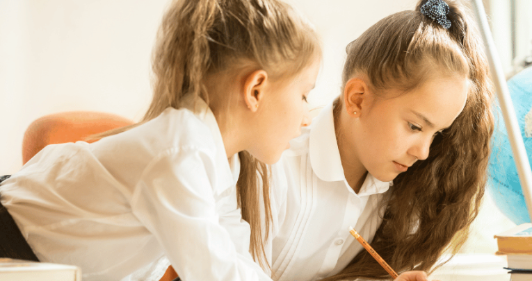 Two schoolchildren doing think pair share