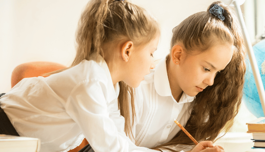 Two schoolchildren doing think pair share