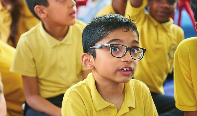 Boy sititng in classroom, representing teaching tricky words
