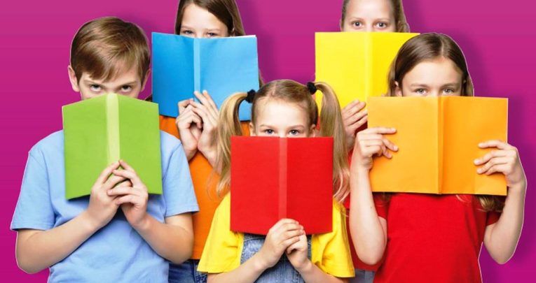 Children hiding behind colourful books for Dyslexia Awareness Week