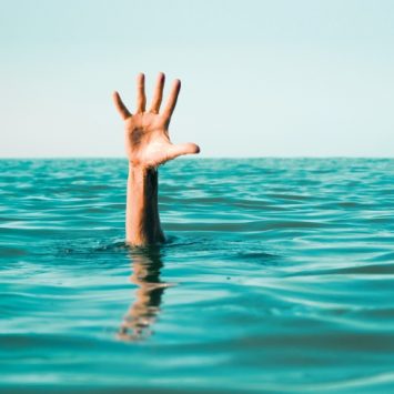 Waving hand in ocean, representing struggling early career teachers