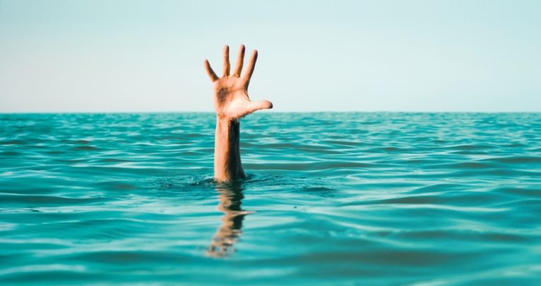 Waving hand in ocean, representing struggling early career teachers