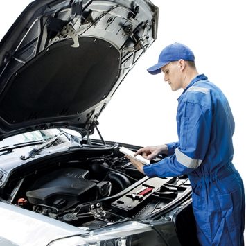 Photo of a car mechanic inspecting a car engine, representing teaching English