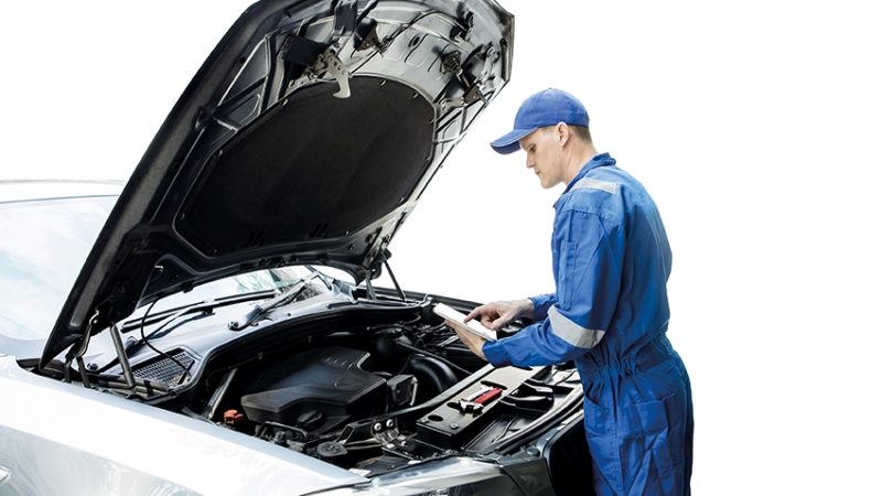 Photo of a car mechanic inspecting a car engine, representing teaching English