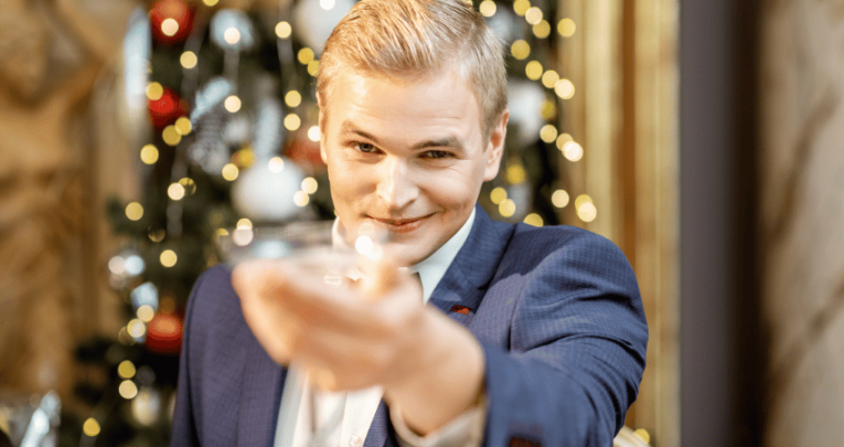 Photo of man, representing Gatsby, raising a glass of champagne, representing Banned Books Week