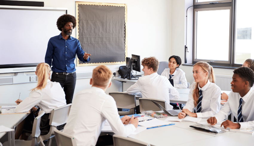 Secondary pupils in classroom learning about school rules