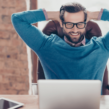 Happy teacher leaning back, representing overcoming teacher stress