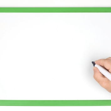 Student writing on mini whiteboard